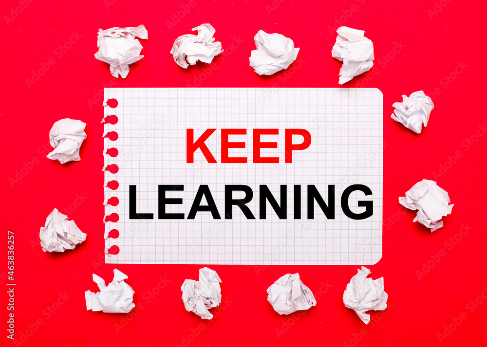 Poster on a bright red background, white crumpled sheets of paper and a sheet of paper with the text keep l