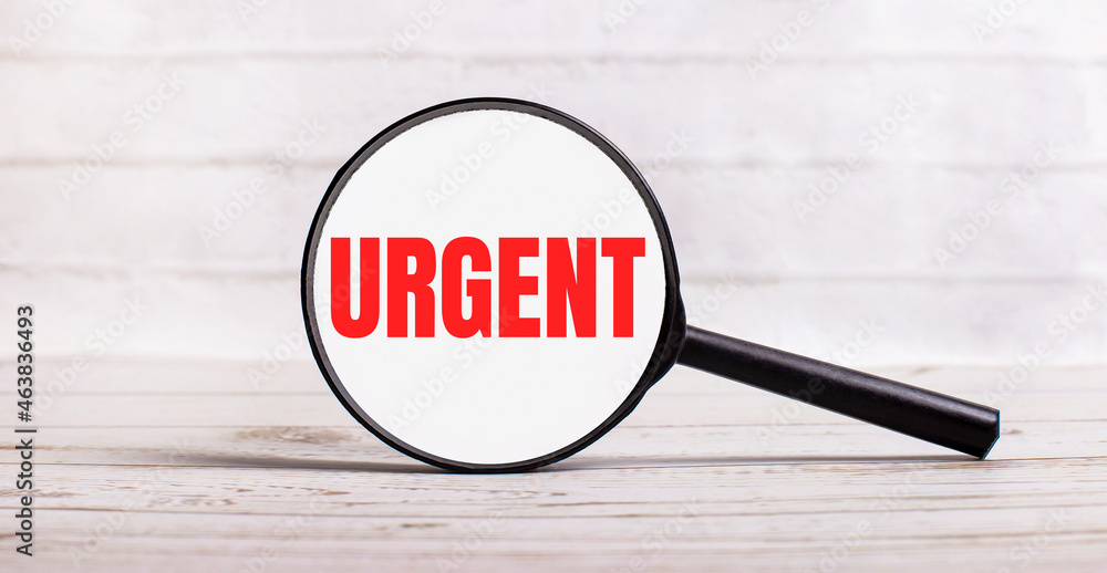 Poster the magnifying glass stands vertically on a light background with the text urgent