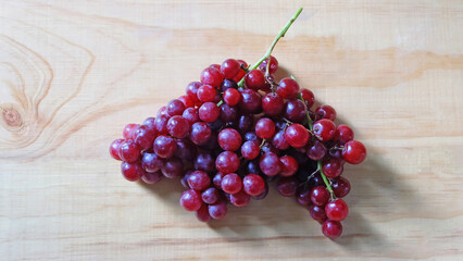 Bunch of grapes on wooden background. Raw fruit healthy food