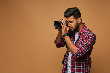 Indian photographer with camera on pastel background copy space