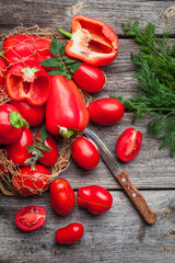 Fresh vegetables, sweet tomatoes and bell peppers on wooden background. Organic food. Top view