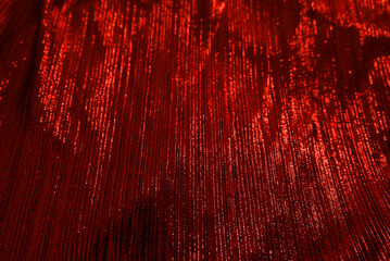 Red reflect velvet fabric texture used as background. Empty red fabric background of soft and...