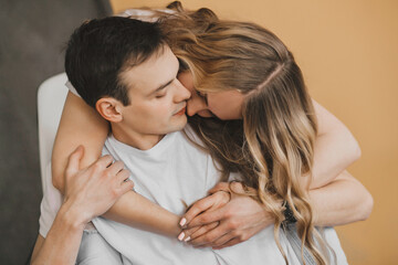 Close up portrait of young attractive romantic couple hugging, being loving with each other. Love and relationships lifestyle