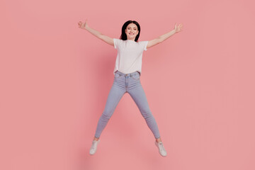 Fototapeta na wymiar Photo of positive jumper carefree funny lady jump have fun isolated on pink color background
