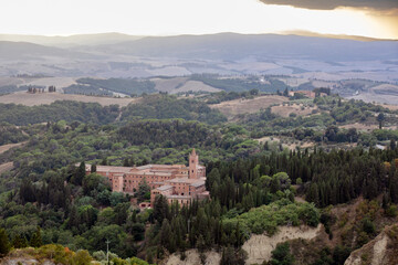 Fototapeta na wymiar Chiusure, Asciano (SI), Italy - August 15, 2021: Landscape view from Chiusure village and Monteoliveto Maggiore Abbey, Asciano, Tuscany, Italy