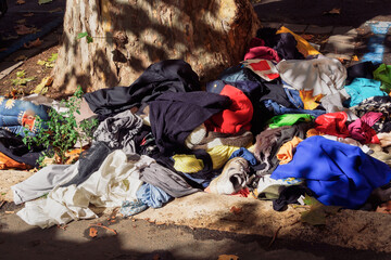 Rome, Italy garbage on the streets next to a pavement. Trash including clothes spread outside...