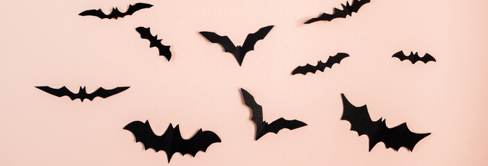 Happy Halloween. Bats on pink pastel background.