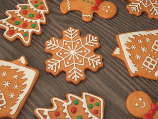 Gingerbread man, house, snowflake, Christmas tree on a wooden background, 3d render