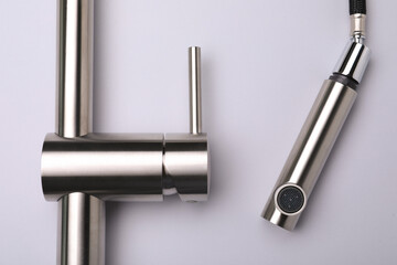 Modern pull out kitchen faucet on grey background, top view