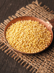 Copper bowl filled with hulled organic millet