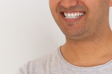 Obraz premium Close up photo of brown skinned young adult man smiling. White teeth concept.