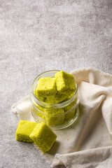 coconut toffees, sugary snack in a glass container, closeup view