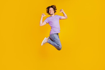 Fototapeta na wymiar Photo of positive confident man jump direct thumb fingers himself wear casual jeans clothes on yellow background