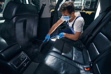 Steam cleaning of car cabin with vacuum device