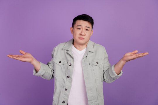 Clueless indifferent korean man shrug shoudlers dont know answer doubt uncertain unsure mood