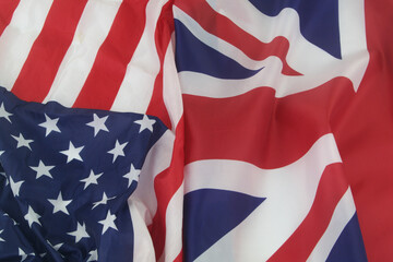 UK and USA collaboration and cooperation concept. British and United States flags as background.