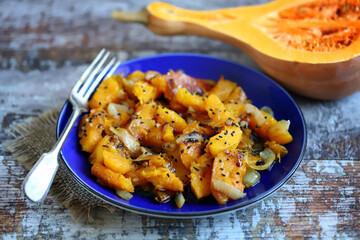 Delicious baked pumpkin with onions. Autumn dishes. Vegan diet.