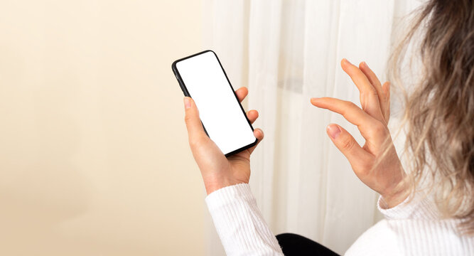 Woman holding smart phone with screen mock up. © vahit