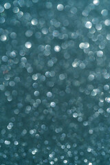 Sea wave abstract glitter background with shiny bokeh