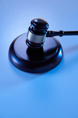  wooden judge gavel and soundboard isolated on blue background