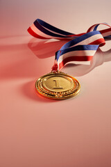 gold medal on pink background