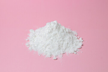 Isolated Powdered Sugar. Sugar powder on a pink background. Baking ingredient.