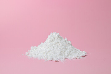 Isolated Powdered Sugar. Sugar powder on a pink background. Baking ingredient.