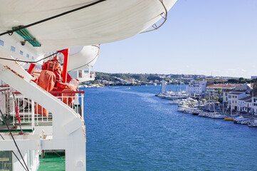 lifeboat suspended above the deck of the Mediterranean ferry leaving the port of Mahon