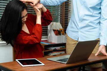 Boss attempts to touch the shoulder of a young female employee in office at workplace. She is uncomfortable and afraid of sexual inappropriate abuse. Concept of sexual harassment in the workplace - obrazy, fototapety, plakaty