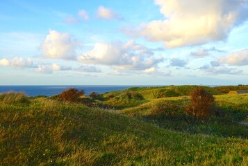 landscape at Cap Gris-Nez with hilly meadows in the foreground and the ocean in the background at the evening, opal coast, Pas-de-Calais, Hauts-de-France, France