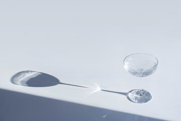 Empty coupe on a white table with a shadow