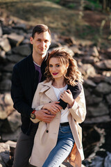 Happy woman hugging her male friend outdoors