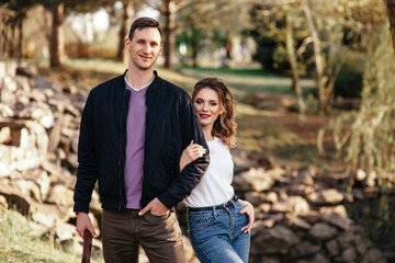 Happy woman hugging her male friend outdoors