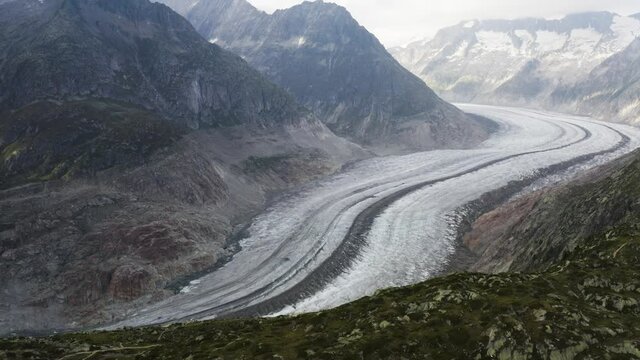 Aerial shows Aletschglacier and a bird passes by, Switzerland