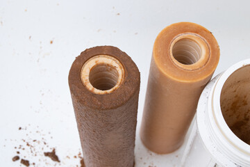 Dirty rusty filter for water purification. Multi-stage drinking water filter cartridge replacement