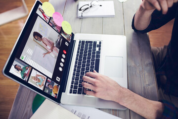 Hands of man using laptop for video call, with smiling diverse elementary school pupils on screen