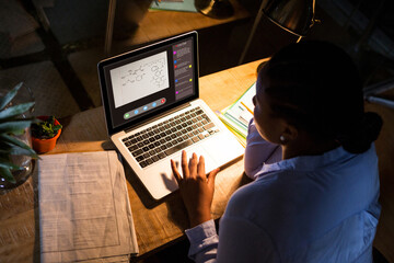 African american woman using laptop for video call, with class on screen