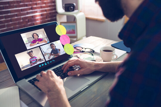 Caucasian man using laptop for video call, with smiling diverse elementary school pupils on screen