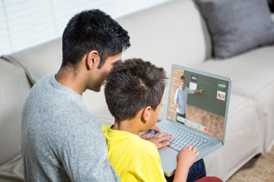 Biracial boy with father using laptop for video call, with male teacher on screen