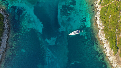 Fototapeta na wymiar Aerial drone photo of turquoise paradise bay visited by yachts and sail boats in Caribbean island destination