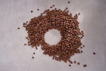 Roasted coffee beans on gray granite background.  Selective focus