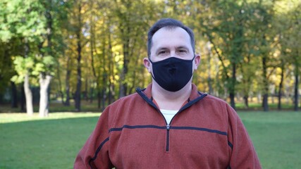 Man take off black protective mask