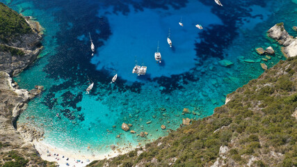 Aerial drone photo of iconic paradise bay and rocky beach of Erimitis in island of Paxos visited by luxury yachts and sail boats, Ionian, Greece