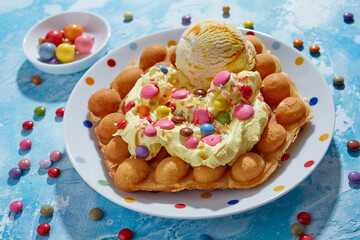 Delicious bubble waffle with ice cream placed on plate