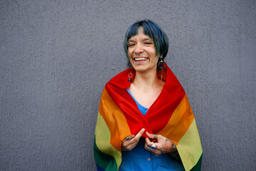 Beautiful young woman with shirt blue hair covered  in rainbow flag