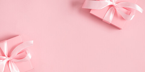 Gift or present box on pastel pink table. Pink background with gift. Flat lay, top view, copy space. banner