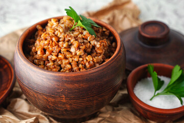 A pot of buckwheat porridge close up. Balanced nutrition, anti-crisis food. Diet healthy lunch or lunch. Rustic style