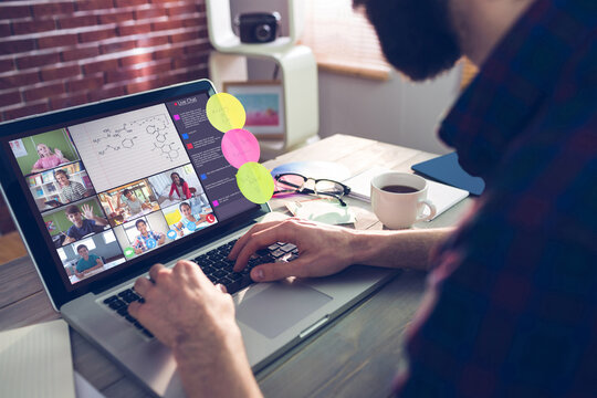 Caucasian man using laptop for video call, with diverse elementary school pupils on screen