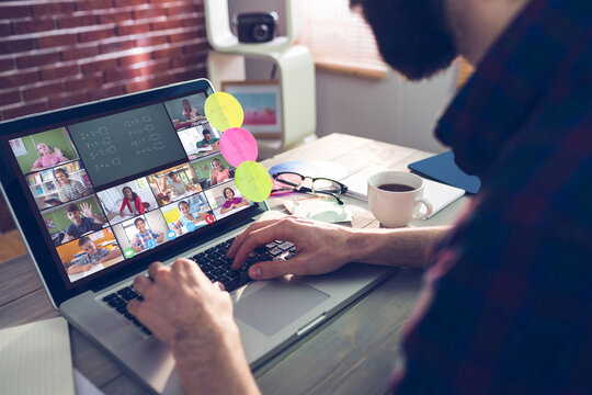 Caucasian man using laptop for video call, with diverse elementary school pupils on screen