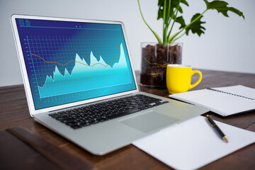 Fototapeta premium Laptop lying on desk with statistical data on screen